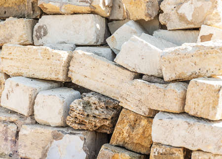 Old sandstone bricks in a yard. Sandstone brick pile close upの写真素材