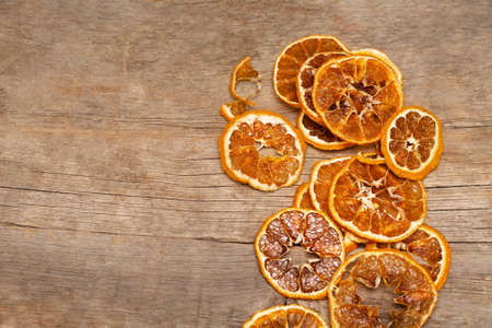 Dry oranges and grapefruit slices on a rustic wooden table. Christmas fruit decoration. Citrus drink...