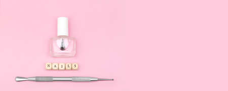 Top view on manicure equipment set. female nail care equipment. Manicure and pedicure equipment on pink background. copy space. advertising banner. banner ad template.の写真素材