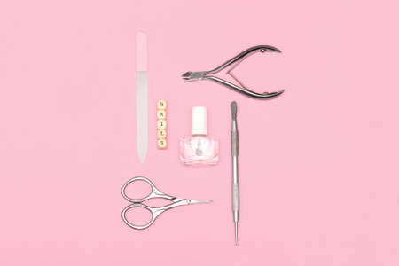 Top view on manicure equipment set. female nail care equipment. Manicure and pedicure equipment on pink background. copy spaceの写真素材