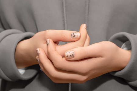 Female model hands with clear nail design. Glitter clear nail polish manicure with green nail art....