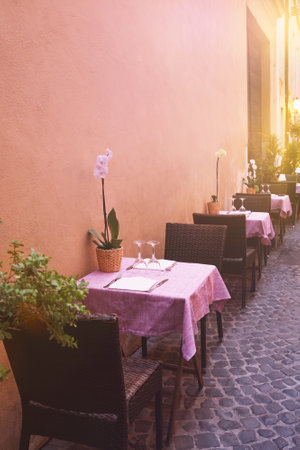 Street italian restaurant, small tables for two with pink tablecloth. Street cafes in Italy. Travel to Italy. Travel, restautant or tourism design background.の写真素材