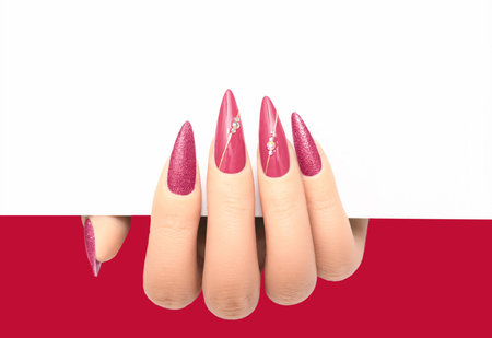 Female hand wih perfect red stiletto manicure holding white paper on white background. Template for postcard, advertising banner or message. Nails card design element.の写真素材