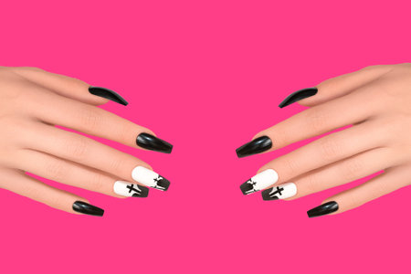 Halloween nail design black white color with cross. Female hand with autumn manicure, top view. Halloween conceptの写真素材