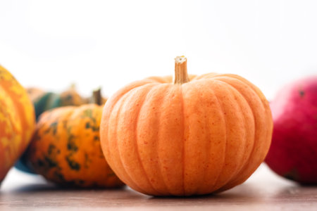 Orange halloween pumpkins on wooden table, holiday decoration. Preparation for Halloween celebratingの写真素材