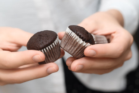 Woman holding tasty chocolate cupcakeの写真素材