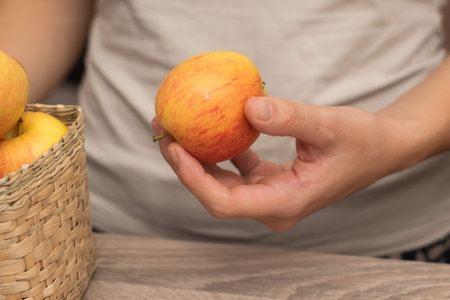 Hand Picking a Fresh Apple. Female hand holding fresh ripe appleの写真素材