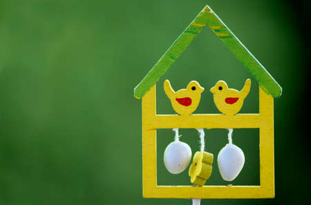 Abstract bird house for easter decoration on green background.の写真素材