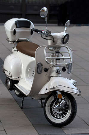 White classic scooter.Small vintage city motorbike parked on the street.の写真素材