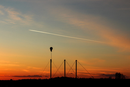 Sunset with plane in distance and 3 pillarsの写真素材