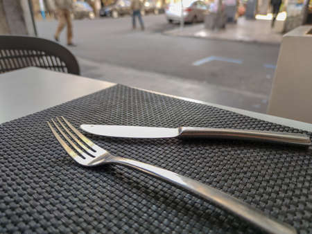 a fork and a knife in a restaurant tableの写真素材