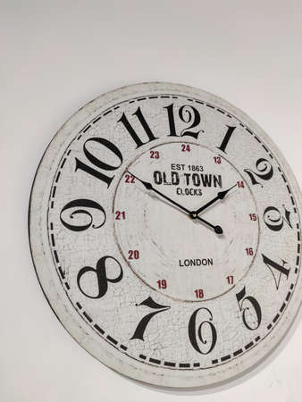 a white clock hanging on the wallの写真素材