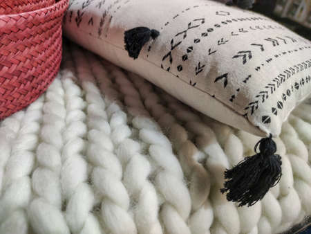 a white pillow on a wool sofaの写真素材