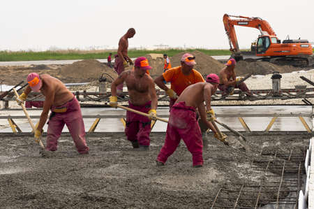 Group of workes is placing concrete layerのeditorial素材