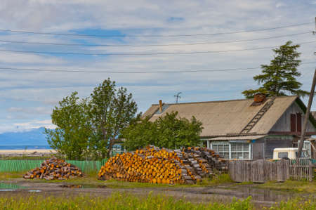 Wood stack is near village houseのeditorial素材