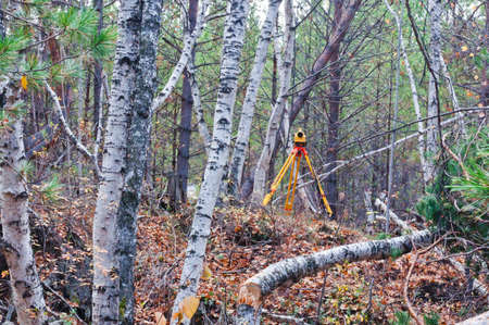Survey in forest. Digital levelの写真素材