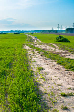  man going on the green field with mountain bikeの写真素材