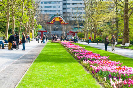 Alley with pass and flowers with walking people in fron of Zoo gate. Berlin Zoo, may 2013.のeditorial素材