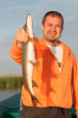 pike in fisherman's hand, fishing in Volga.の写真素材