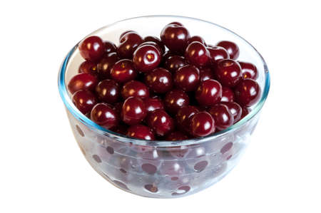Glass bown with cherry berries on whiteの写真素材