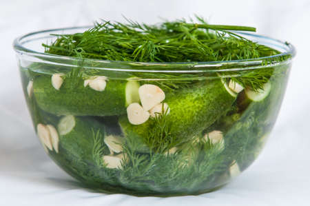 Glass bowl with marinate cucumbers on whiteの写真素材