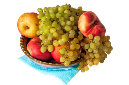 Plate with fruits: white grapes, pear, fig peach.の写真素材