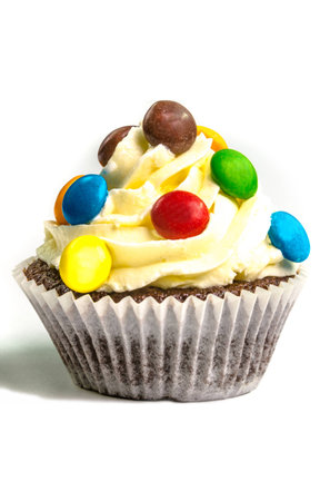 Yellow creamed sweet cupcake on white backgroundの写真素材