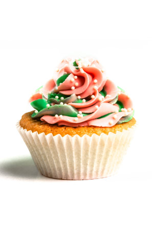 Pink-green creamed sweet cupcake on white backgroundの写真素材
