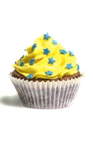 Yellow creamed sweet cupcake on white background