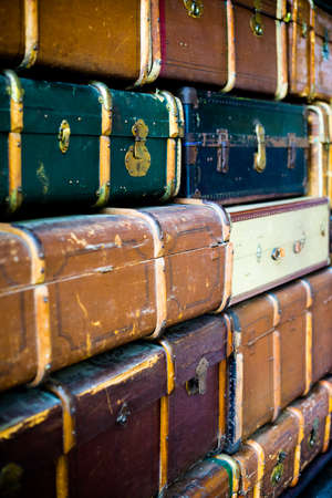 Abstract textured background created by a pile of old grungy cabin trunks with locks and reinforcing bars.の写真素材