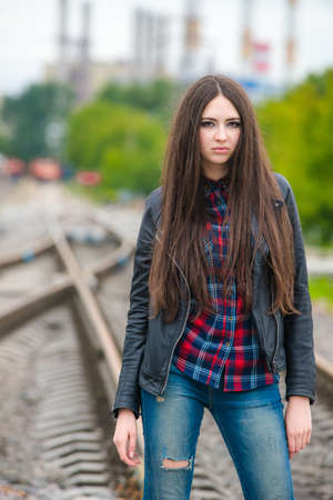 Girl at railroad in Moscow with power station in background の写真素材