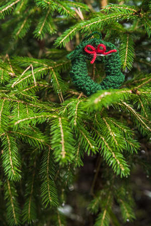 Knitted Chrismas toys on green fir branchesの写真素材