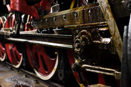 Old locomotive fragment with guide mechanism and wheels
