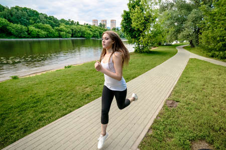 Park jogging. Nice girl is running in Serebryaniy Bor in Moscowの写真素材