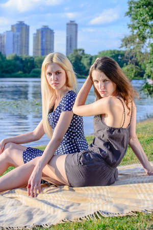 Girls'are outside going green with picnic at riversideの写真素材