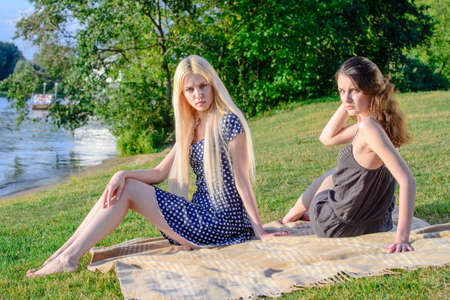 Girls'are outside going green with picnic at riversideの写真素材