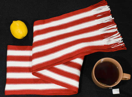 Composition with red-white scarf, lemon and teacupの写真素材