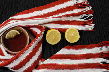 Composition with red-white scarf, lemon and teacupの写真素材