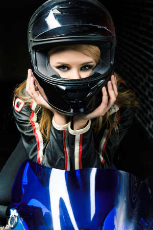 Moto close up of young girl in black helmet. Retouched image.の写真素材