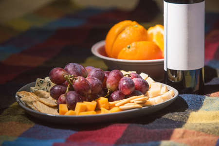 Served table with wine bottle covered with colored blanketの写真素材