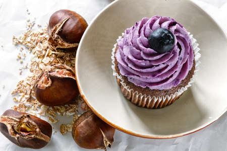 Still life with capcake, chestnuts and flakesの写真素材