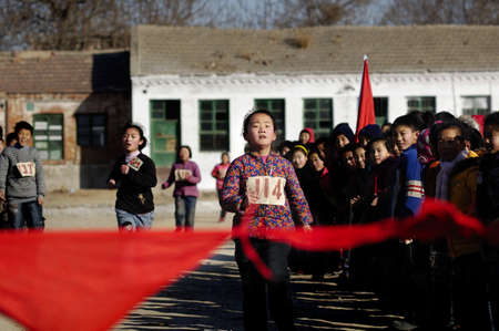 In a rural school, the children in the game. Although conditions are difficult, but the enthusiasm of the children but can melt the cold. December 31, 2010, China, Xingtai City, Hebei Province.のeditorial素材
