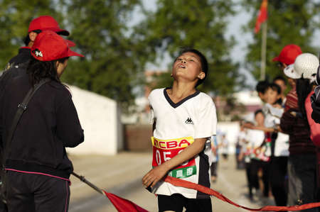 In the student movement, students are to demonstrate the tenacity of will and fighting spirit. This photo is a wonderful sprinter crossing the finish line when the shot. Xingtai City, Hebei Province, China, May 12, 2011.のeditorial素材