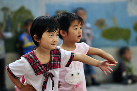 During the Children's Day, kindergarten art party was held. Party program to perform all of the children. This picture is when children show moments. Xingtai City, Hebei Province, China, May 28, 2011.のeditorial素材