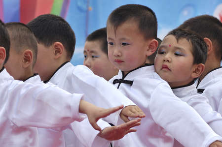 During the Children's Day, kindergarten art party was held. Party program to perform all of the children. This picture is when children show moments. Xingtai City, Hebei Province, China, May 29, 2011.のeditorial素材