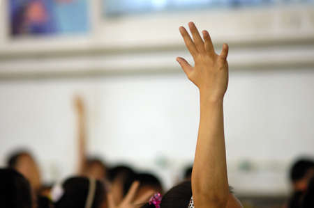 The classroom, the students were very involved, actively and enthusiastically raised their hands to answer the problem posed by the teacher.の写真素材