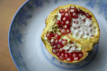 The pomegranate is a highly nutritional value of the fruit.This is half a pomegranate on a plate.