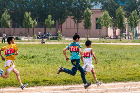 Baixiang County, Hebei Province, China, May 13, 2013. Student Games track race finish, athletes strive first, toward the finish line.のeditorial素材