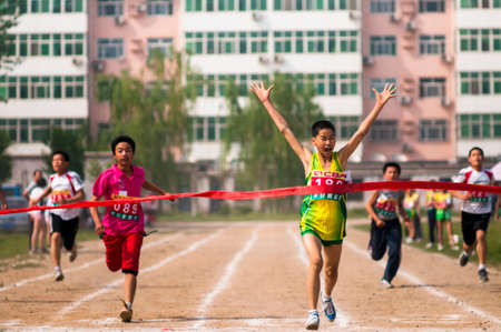 Baixiang County, Hebei Province, China, May 13, 2013. Student Games track race finish, athletes strive first, toward the finish line.のeditorial素材