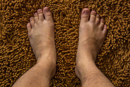 Human foot on brown matの写真素材